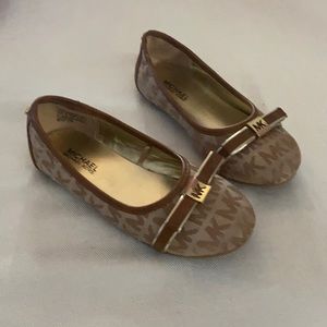 Girls Michael Kors Flat shoe with rubber sole.